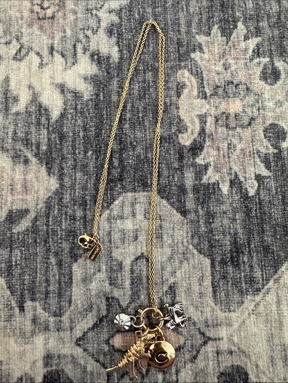 Coach Gold-Tone Charm Necklace with Dinosaur and Medallion Charms
